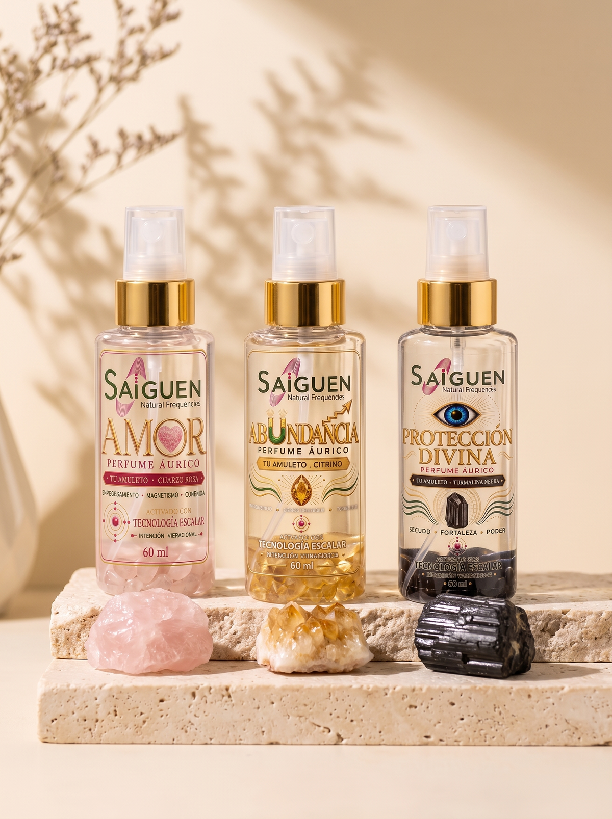 Los tres perfumes áuricos Saiguen con sus cristales sobre piedra clara